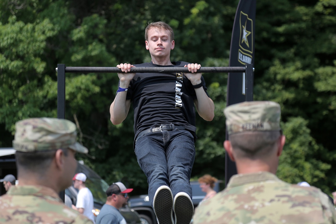 David Williams, from Oak Creek, Wisconsin, performs pull-ups during the Fourth of July NASCAR Cup Series race at Road America, Elkhart Lake, Wisconsin, July 4, 2021.