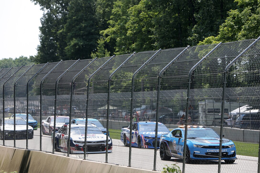 The pace car leads drivers in the initial lap across a four-mile track during the Fourth of July NASCAR Cup Series race at Road America, Elkhart Lake, Wisconsin, July 4, 2021.