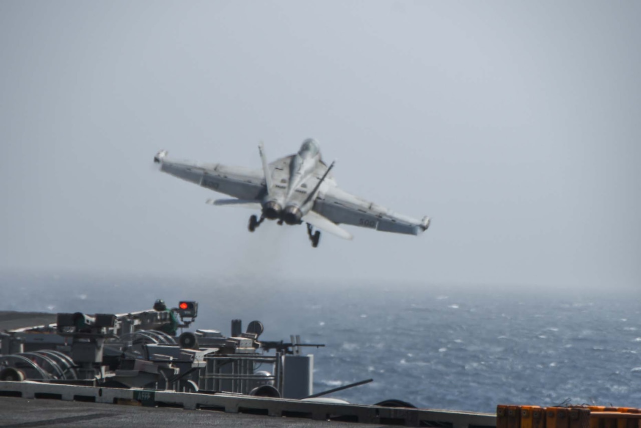 A jet takes off from a carrier.
