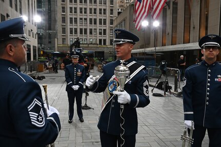 U.S. Air Force Chief Master Sgt. Daniel Valadie, drum major, talks with his fellow members of The United States Air Force Band’s Ceremonial Brass before recording for a live TODAY Show broadcast in New York City on July 2, 2021. The official ceremonial ensemble comprises 41 active-duty Airmen who provide musical support for funerals at Arlington National Cemetery, arrivals for foreign heads of state at the White House and Pentagon, patriotic programs, changes of command, retirements, and awards ceremonies. (U.S. Air Force photo by Staff Sgt. Kayla White)