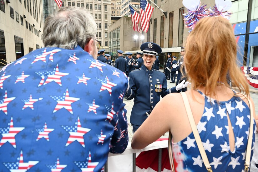 U.S. Air Force Capt. Christina Muncey, premier band flight commander and associate conductor with The United States Air Force Band, engages with audience members before leading the Ceremonial Brass during a live broadcast on the TODAY Show in New York City July 2, 2021. The official ceremonial ensemble comprises 41 active-duty Airmen who provide musical support for funerals at Arlington National Cemetery, arrivals for foreign heads of state at the White House and Pentagon, patriotic programs, changes of command, retirements, and awards ceremonies. (U.S. Air Force photo by Staff Sgt. Kayla White)