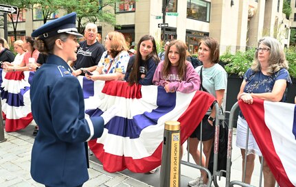 U.S. Air Force Capt. Christina Muncey, premier band flight commander and associate conductor with The United States Air Force Band, engages with audience members before leading the Ceremonial Brass during a live broadcast on the TODAY Show in New York City July 2, 2021. The official ceremonial ensemble comprises 41 active-duty Airmen who provide musical support for funerals at Arlington National Cemetery, arrivals for foreign heads of state at the White House and Pentagon, patriotic programs, changes of command, retirements, and awards ceremonies. (U.S. Air Force photo by Staff Sgt. Kayla White)