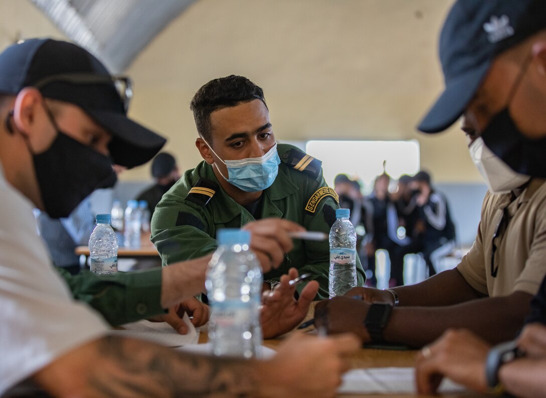 U.S. Army Soldiers, assigned to 404th Civil Affairs Battalion and the Moroccan Gendarmerie, conduct a mass-screening event in Tifnit, Morocco, on June 13, 2021. Africa Lion 2021 is U.S. Africa Command’s largest, premier, joint, annual exercise hosted by Morocco, Tunisia, and Senegal, 7-18 June. More than 7,000 participants from nine nations and NATO train together with a focus on enhancing readiness for U.S. and partner nation forces. Africa Lion 21 is a multi-domain, multi-component, and multinational exercise, which employs a full array of mission and capabilities with the goal to strengthen interoperability among participants.