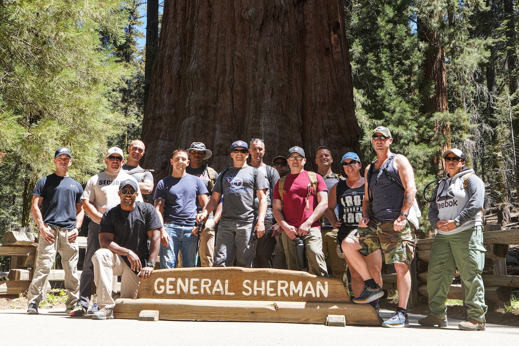 U.S. Marines with I Marine Expeditionary Force Information Group, pose for a group photo in front of the General Sherman Tree at Sequoia National Forest during a leadership retreat by Kaweah Lake, California, May 26, 2021. The three-day retreat in the Sequoia National Forest focused on connectedness and personal growth to increase individual and unit resilience. It provided participants with the tools and resources to shape their units' training programs, build character and equip their peers and subordinates with greater life resiliency skills. The interconnectedness of the roots of the Sequoia trees is a metaphor for the network of Marines and sailors that rely on each other through every rank and life situation. The trees are also a metaphor for unit Esprit-de-Corps that expands across a much larger national network. This inaugural retreat set the foundation for future, similar events that will include conditioning events, lectures, guided discussions and guest speakers. (U.S. Marine Corps Photo by Lance Cpl. Aidan Hekker)