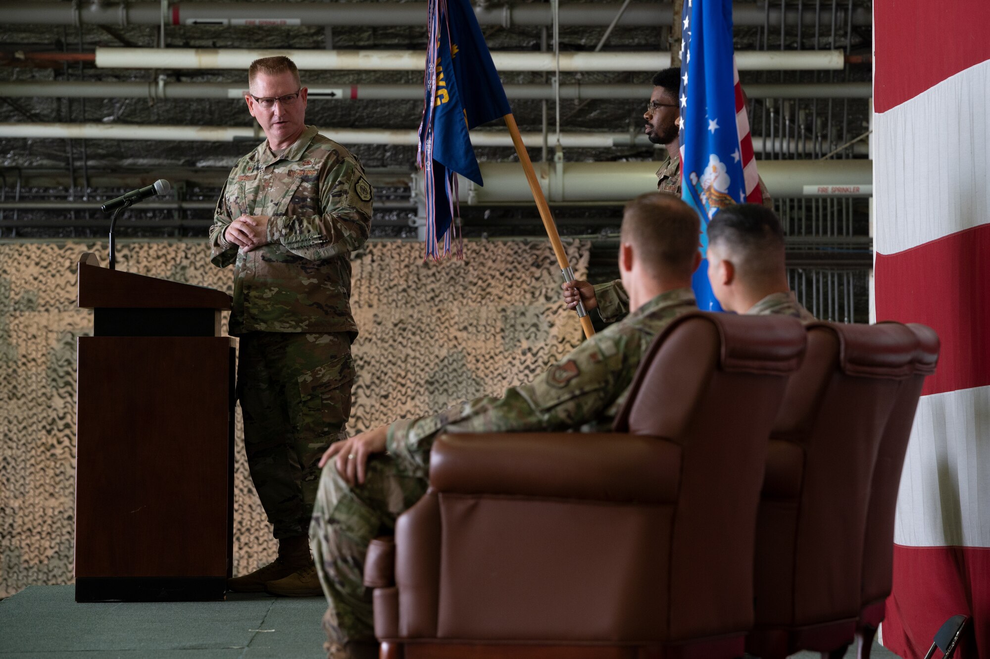 Col. Brian Moore, 51st Maintenance Group commander, left, presides over the 51st Munitions Squadron command ceremony at Osan Air Base, Republic of Korea, July 6, 2021. As the presiding officer, Moore facilitated the transition of 51st MUNS command by receiving the ceremonial guidon from the outgoing officer and presenting it to the incoming officer.  (U.S. Air Force photo by Tech. Sgt. Nicholas Alder)