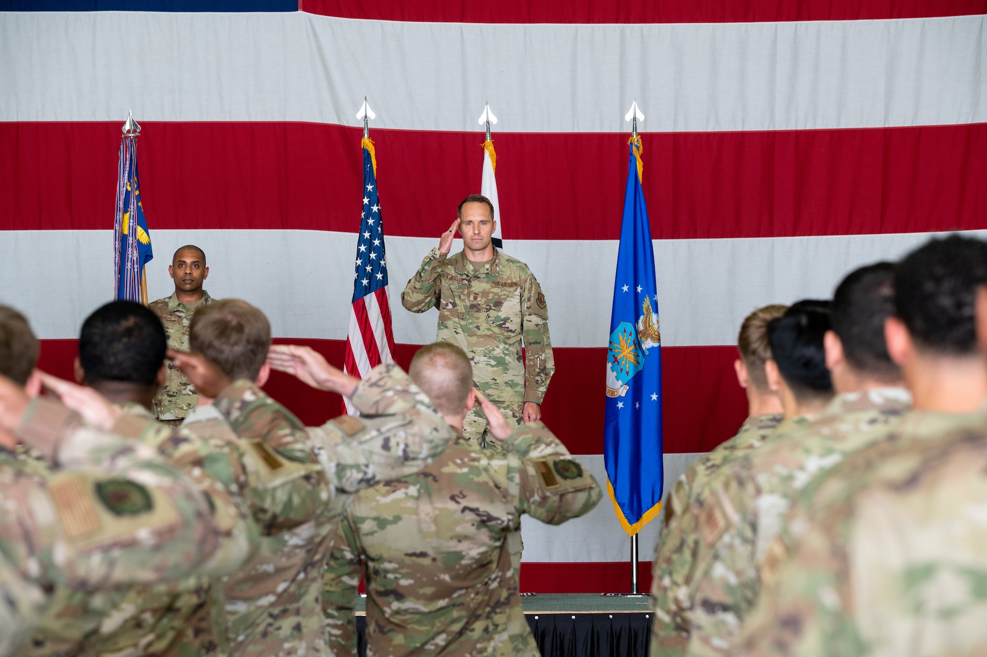 Maj. Scott Kubalek, 51st Munitions Squadron inbound commander, returns a salute to his squadron during the change of command ceremony at Osan Air Base, Republic of Korea, July 6, 2021. The ceremonial passing of the guidon to Kubalek marks the official beginning of his command of the 51st MUNS. (U.S. Air Force photo by Tech. Sgt. Nicholas Alder)