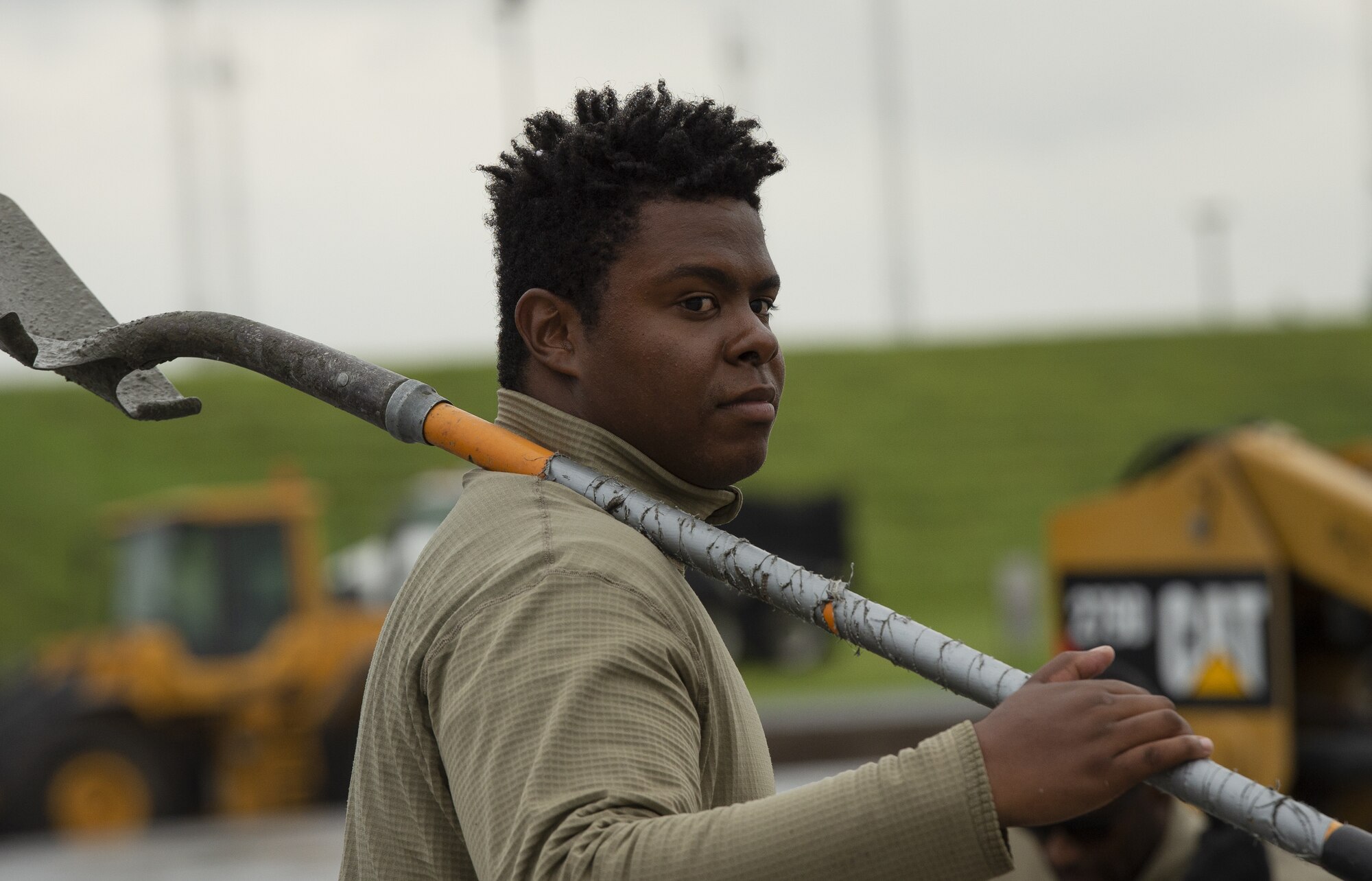Staff Sgt. Dock Griffin, 823rd RED HORSE Squadron services supervisor, waits to level concrete as part of a construction project to expand a flightline apron June 30, 2021, at Yokota Air Base, Japan. Airmen assigned to the 823rd, 819th and 820th RED HORSE Squadrons, combined efforts to increase aircraft parking capabilities. The apron expansion is the first in an approximately four-year phased construction effort to enhance Yokota Air Base’s airlift mission and is the first 800th RED HORSE Group project within the U.S. Indo-Pacific Command. (U.S. Air Force photo by Tech. Sgt. Christopher Hubenthal)