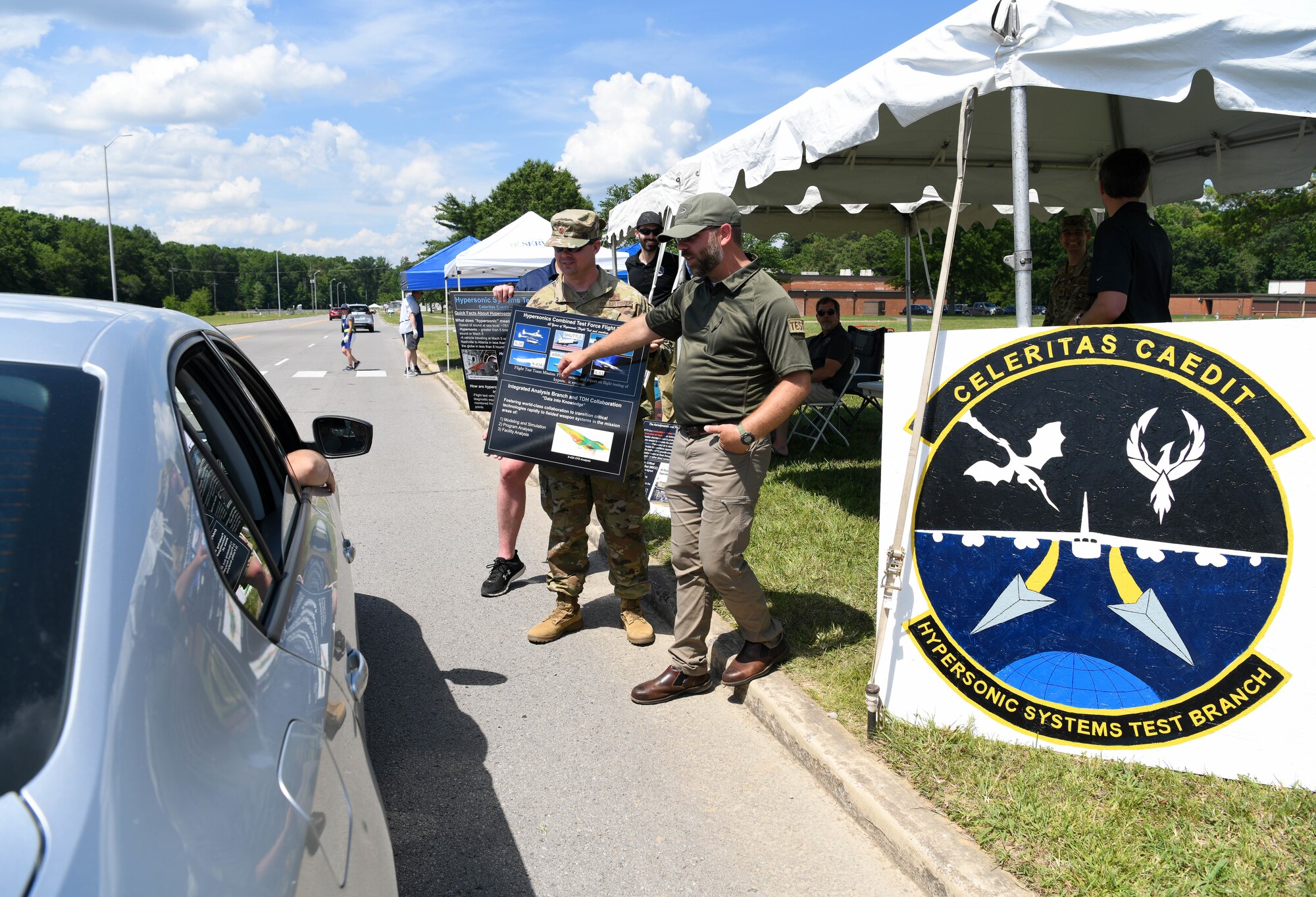 Kirk Butler, right, director of operations, Ground Test Team, Hypersonic Systems Test Branch, Test Division, Arnold Engineering Development Complex, and Maj. Scott Burrows, left, deputy branch chief, Hypersonic Systems Test Branch, speak about the branch to attendees of the AEDC “Hap Arnold Day” 70th Anniversary Celebration Open House, June 26, 2021, at Arnold Air Force Base, Tenn. (U.S. Air Force photo by Jill Pickett)