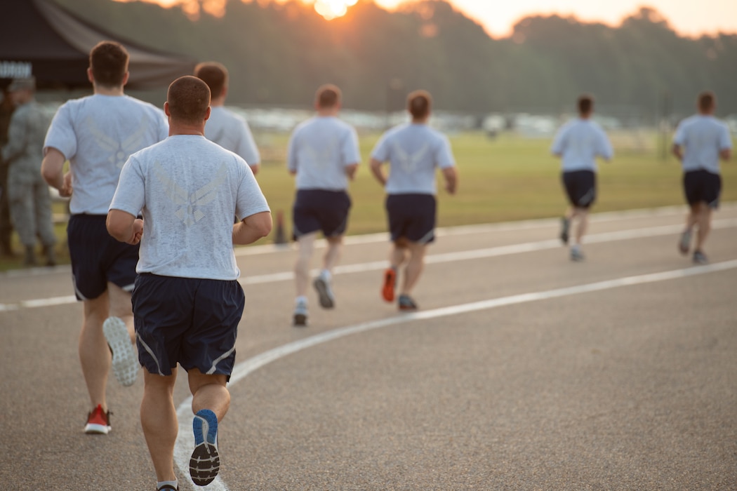 Airmen running around a track