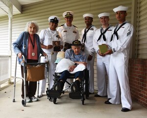 Sailors assigned to the future Virginia-class submarine PCU Massachusetts (SSN 798) stand World War II Veteran Baker 2nd Class Phil Dorf and his wife Etta during a visit July 2nd in Freehold New Jersey.