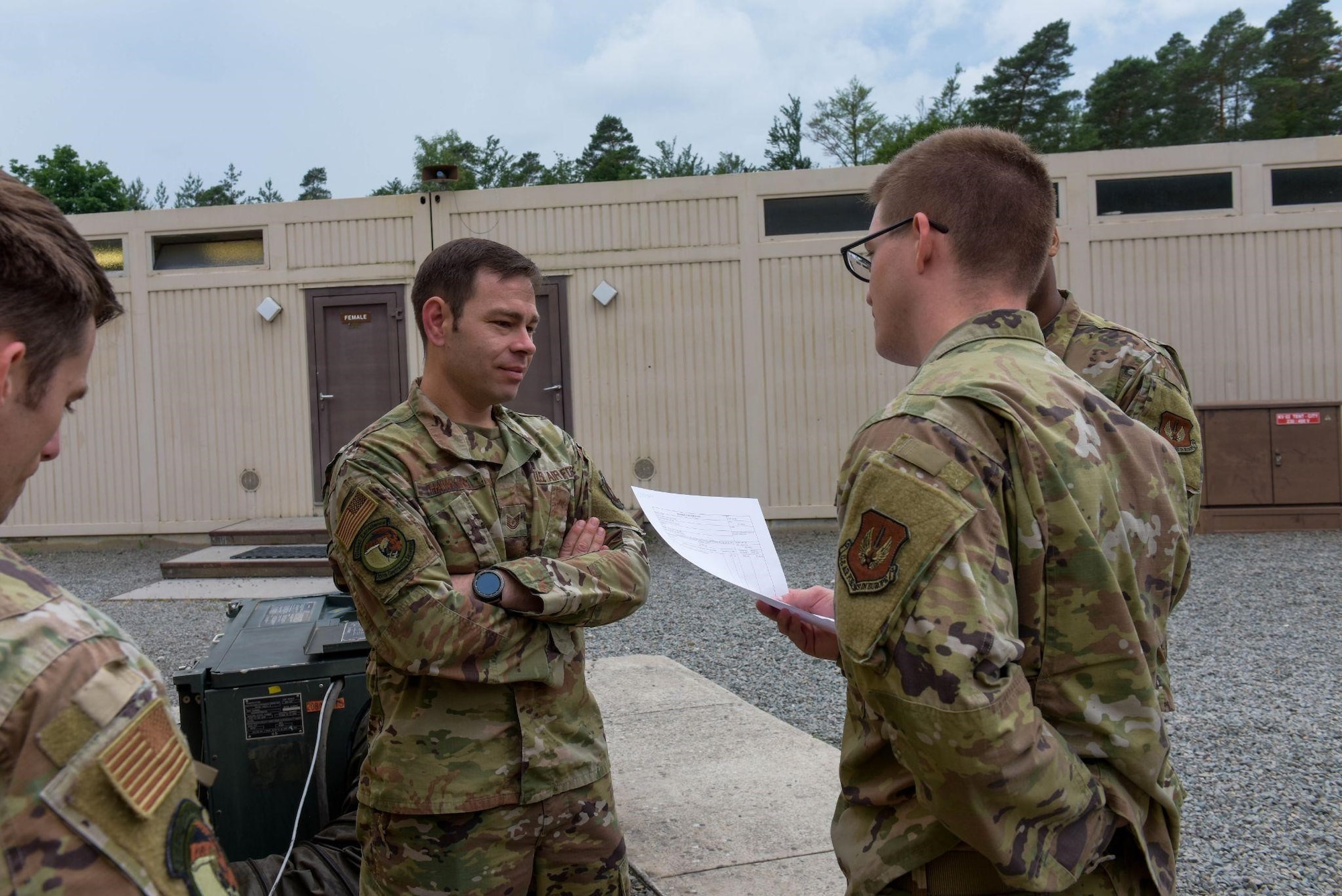 U.S. Air Force Airmen from the 700th Contracting Squadron present their contract they created for a training exercise to a contracting specialist on Ramstein Air Base, Germany, June 28, 2021. As a part of the exercise, the participating Airmen presented their contract to the commander of the 700th CONS. (U.S. Air Force photo by Airman 1st Class Madelyn Keech)