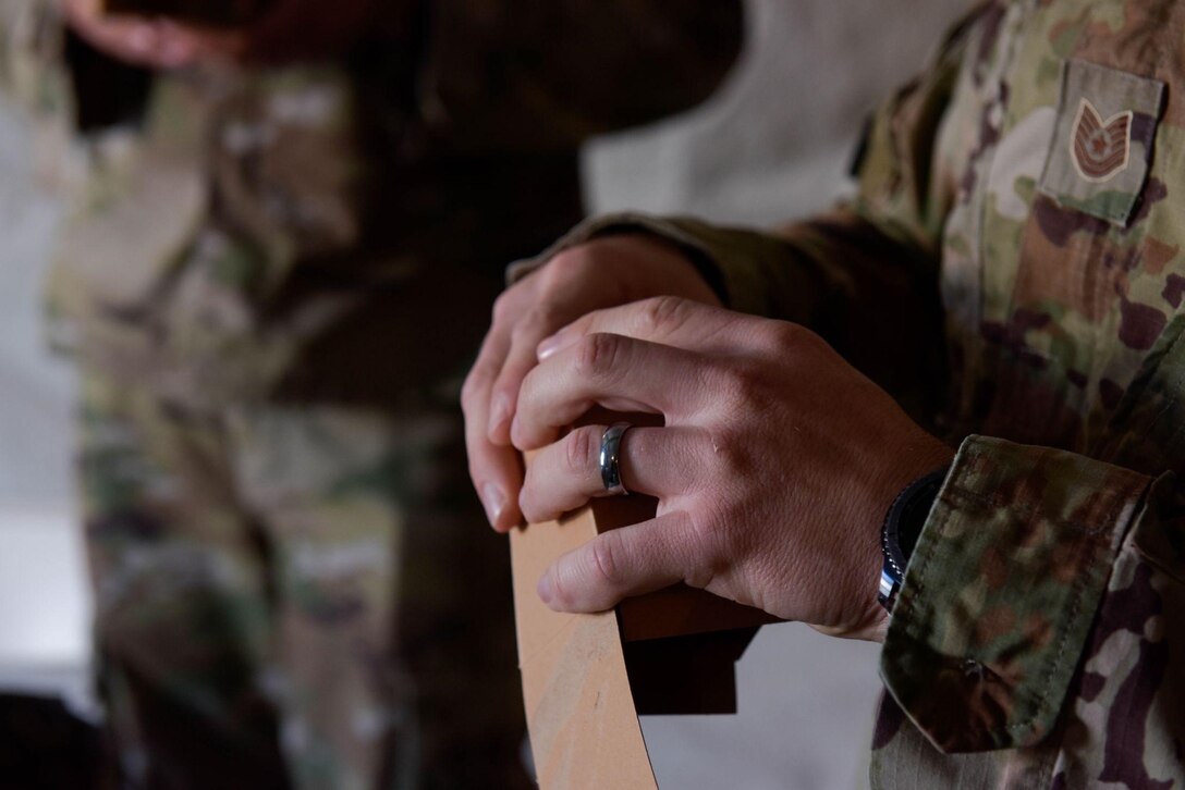 U.S. Air Force Tech Sgt. Jacob Hawkins, a contracting specialist from the 700th Contracting Squadron, folds a box on Ramstein Air Base, Germany, June 28, 2021. The boxes were used as a part of a contracting exercise to show an order with its requirements fulfilled. (U.S. Air Force photo by Airman 1st Class Madelyn Keech)