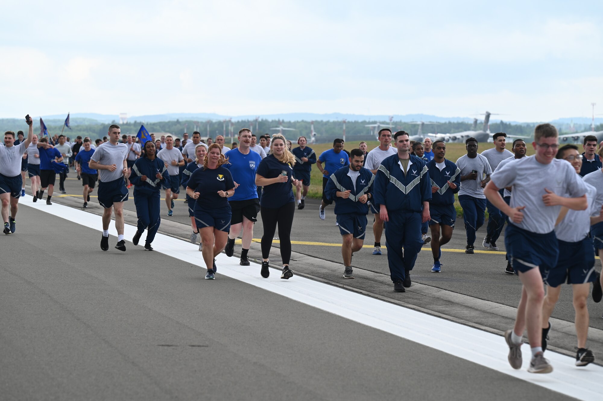 U.S. Air Force Airmen run down the flightline at Ramstein Air base, Germany, July 1, 2021. Airmen from all squadrons in the 86th Airlift Wing participated in the RUNway 5K run to kick off the Fourth of July weekend. (U.S. Air Force photo by Senior Airman Thomas Karol)