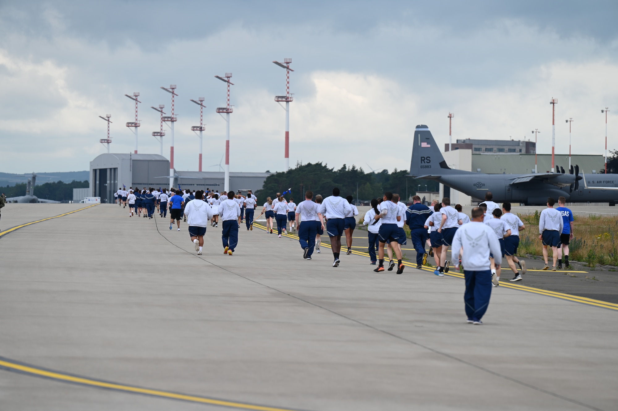 U.S. Air Force Airmen run toward the finish line of the RUNway 5K run at Ramstein Air Base, Germany, July 1, 2021. Airmen from the 86th Airlift Wing participated in the RUNway run in order to increase their physical fitness. (U.S. Air Force photo by Senior Airman Thomas Karol)