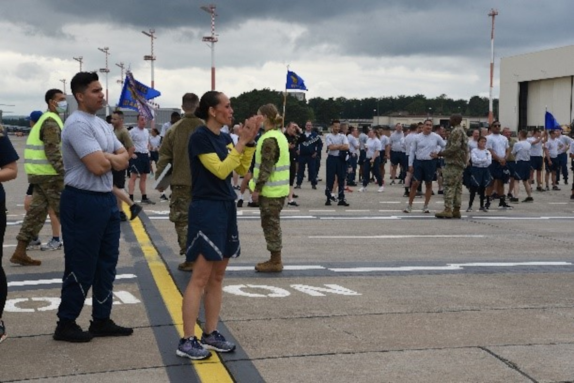 U.S. Air Force 86th Airlift Wing Command Chief Master Sgt. Hope Skibitsky cheers on runners on the flightline at Ramstein Air Base, Germany, July 1, 2021. Skibitsky and others participated in the 5K run to increase morale and physical fitness as fitness assessments kick off. (U.S. Air Force photo by Jocelyn Ford)
