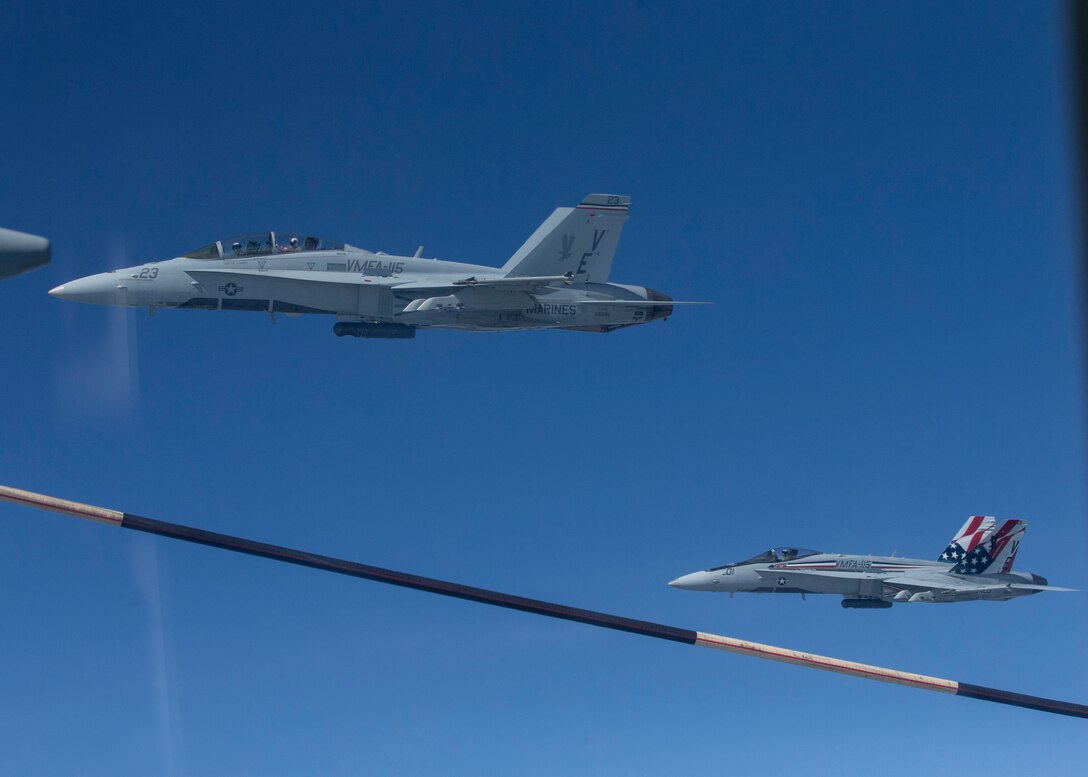 U.S. Marines in F/A-18C and F/A-18D Hornets with Marine Fighter Attack Squadron (VMFA) 115 conduct aerial refueling from a Marine Aerial Refueler and Transport Squadron (VMGR) 452 KC-130J Super Hercules over Rissala Air Base, near Kuopio, Finland, June 8, 2021. Marines with VMFA-115 and VMGR-452 are deployed to Kuopio, Finland in support of Squadron Visit ILVES (Finnish for “Lynx”). The purpose of Squadron Visit ILVES is to conduct air-to-air and air-to-ground training, improve proficiency in joint and multinational tactics, and enhance partnerships with international allies. VMFA-115 is a subordinate unit of 2nd Marine Aircraft Wing, the aviation combat element of II Marine Expeditionary Force. (U.S. Marine Corps photo by Lance Cpl. Caleb Stelter)