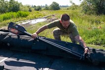 Ukrainian Marines with the 36th Marine Brigade carry a combat rubber reconnaissance craft