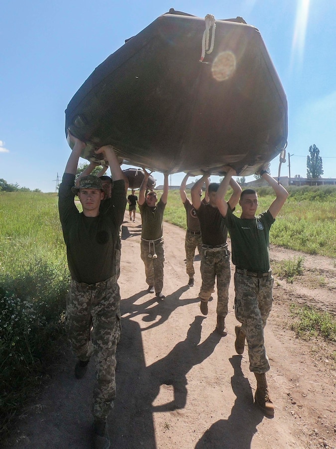 Ukrainian Marines with the 36th Marine Brigade carry a combat rubber reconnaissance craft (CRRC) in Mykolayiv, Ukraine, June 9, 2021. During a nine-day period of instruction, U.S. Marines will teach Marines from Ukraine the basics of operating with the CRRC, a small, lightweight, inflatable, yet rugged boat, useful in a variety of missions requiring speed and stealth. (U.S. Marine Corps photo by Cpl. Claudia Nix)