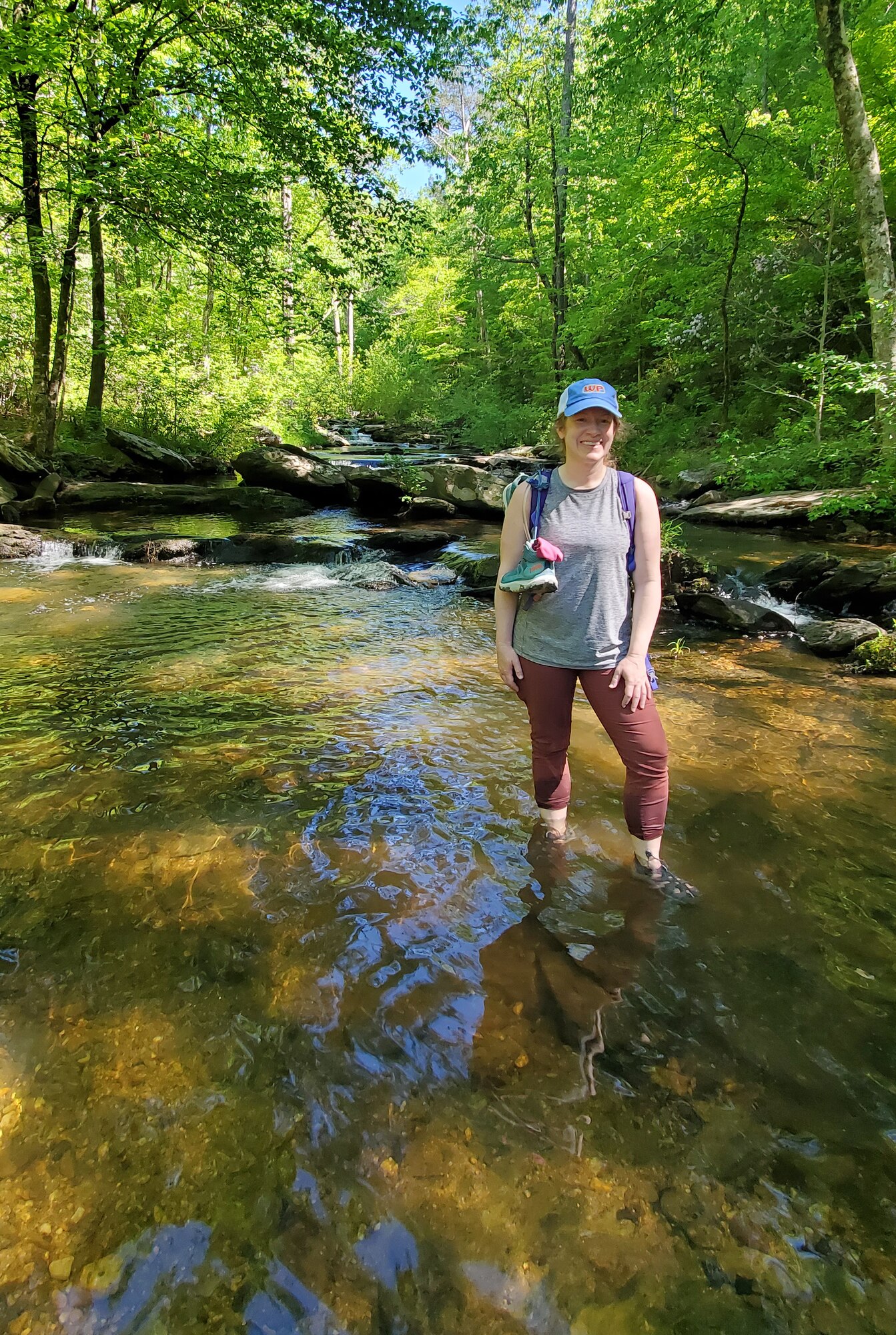 Shannon Allen, the National Environmental Policy Act, Natural and Cultural Resources Planner for Arnold Air Force Base, crosses the Chinnabee Creek while hiking part of the Pinhoti Trail in Alabama during the Make-A-Wish Foundation Alabama Trailblaze Challenge, May 1, 2021. (Courtesy photo)