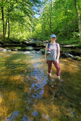 Shannon Allen, the National Environmental Policy Act, Natural and Cultural Resources Planner for Arnold Air Force Base, crosses the Chinnabee Creek while hiking part of the Pinhoti Trail in Alabama during the Make-A-Wish Foundation Alabama Trailblaze Challenge, May 1, 2021. (Courtesy photo)