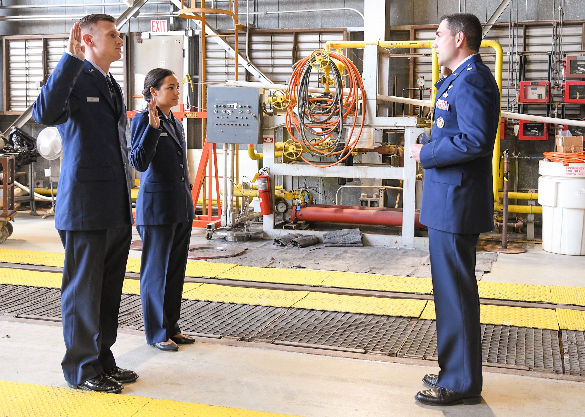 Lt. Col. John McShane, right, materiel leader of the Arnold Engineering Development Complex Aerodynamics Test Branch, administers the oath of office to newly-promoted first lieutenants Ryan Gill and Riley Vaught during a promotion ceremony, May 25, 2021, at Arnold Air Force Base, Tenn. (U.S. Air Force photo by Jill Pickett)