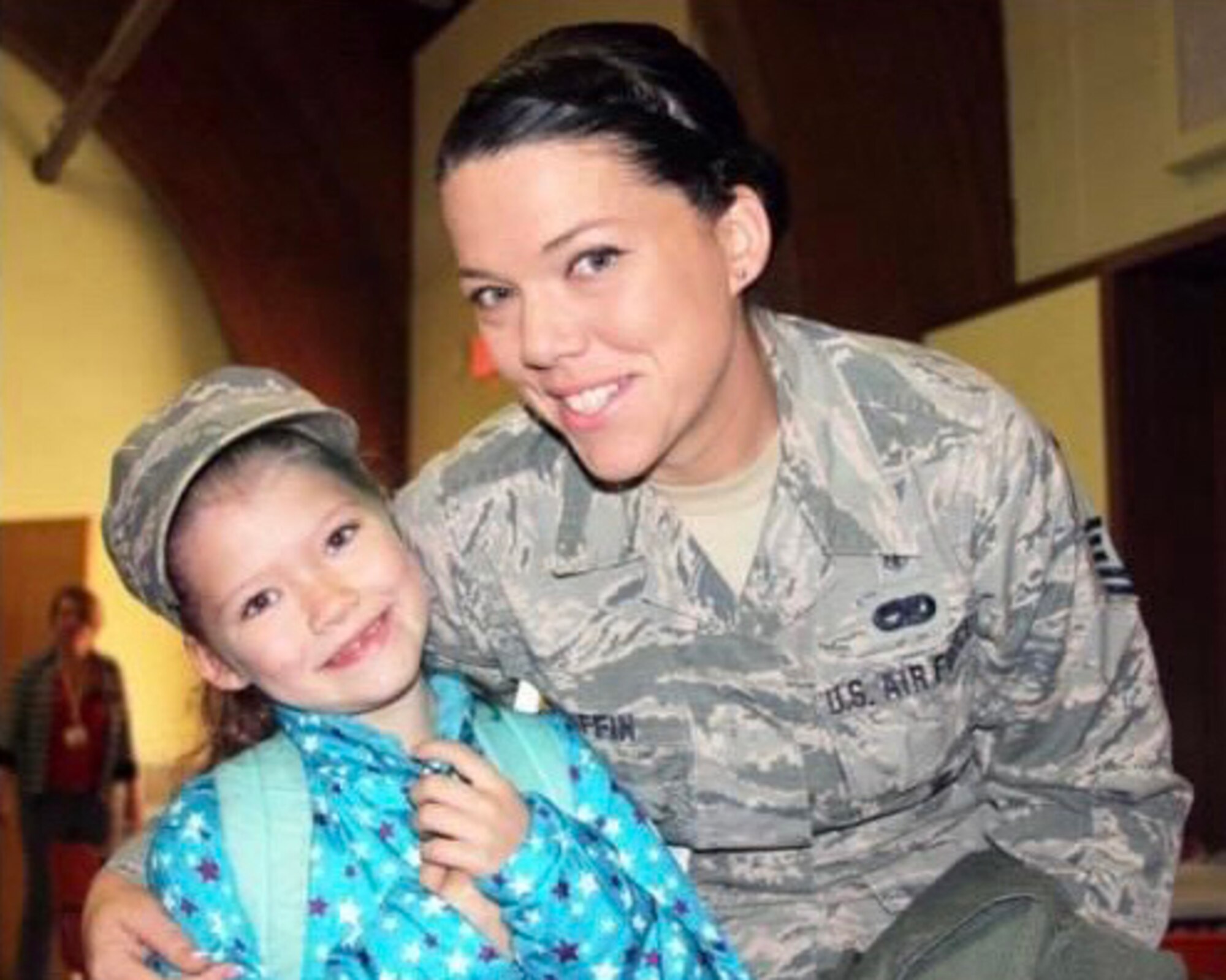 Master Sgt. Erica GriffinKing, 104th dental technician poses with her daughter for a photo during a Veteran's Day breakfast. GriffinKing is a mother to four children and has served in the Air National Guard for 19 years. (Courtesy photo)