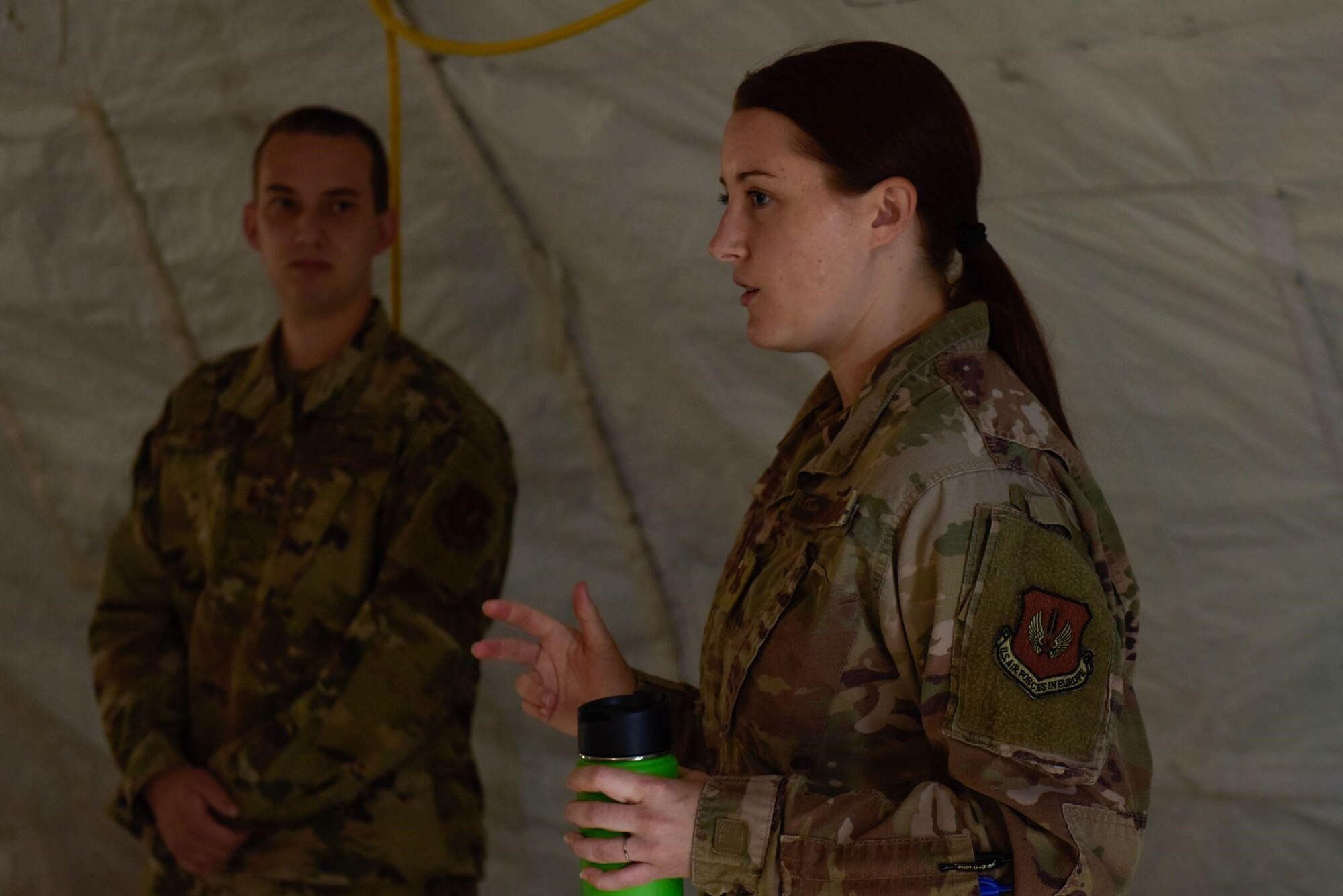 U.S. Air Force 2nd Lt. Grant Wilson, a contracting specialist from the 700th Contracting Squadron, listens to Capt. Teresa Elsbree, another contracting specialist from the 700th CONS, as she explains a contracting training exercise to her Airmen on Ramstein Air Base, Germany, June 28, 2021. This exercise develops Airmen’s readiness for working in a deployed environment. (U.S. Air Force photo by Airman 1st Class Madelyn Keech)