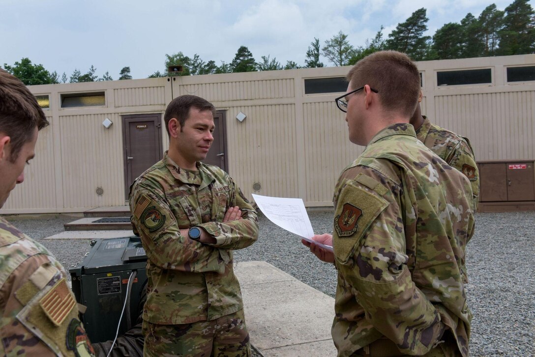 U.S. Air Force Airmen from the 700th Contracting Squadron present their contract they created for a training exercise to a contracting specialist on Ramstein Air Base, Germany, June 28, 2021. As a part of the exercise, the participating Airmen presented their contract to the commander of the 700th CONS. (U.S. Air Force photo by Airman 1st Class Madelyn Keech)