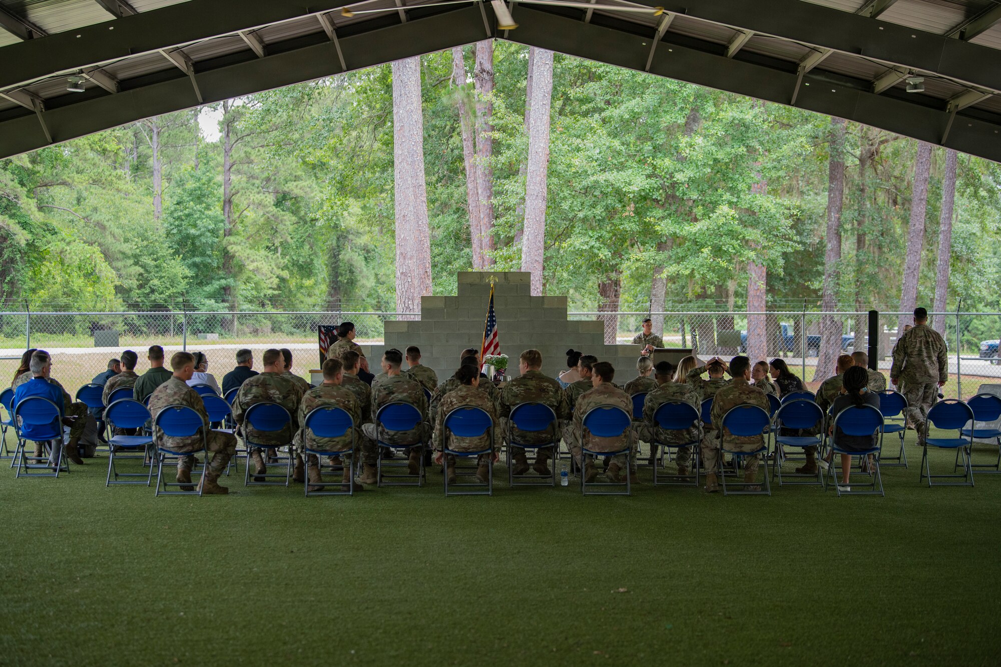 A photo of a group of Airman sitting down in chairs.