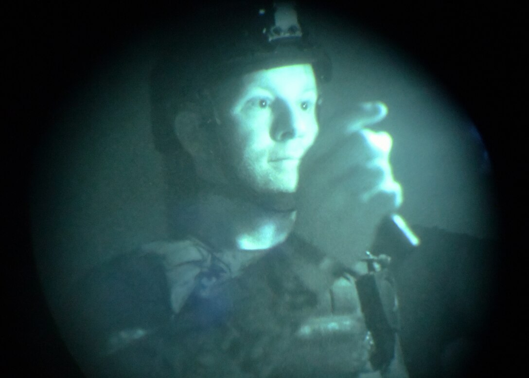 Adam Cavanaugh, New Jersey state police department bomb squad detective, advances through a no light/low light training scenario during Raven's Challenge Interoperability Exercise June 9, 2021, at Fort Devens Army Base, Devens, Massachusetts. The NJPD and Airmen from the 104th Fighter Wing spent a week at the exercise training together in various scenarios, promoting interoperability between the agencies in operational environments while promoting teamwork and innovation.  (U.S. Air National Guard photo by Senior Airman Sara Kolinski)