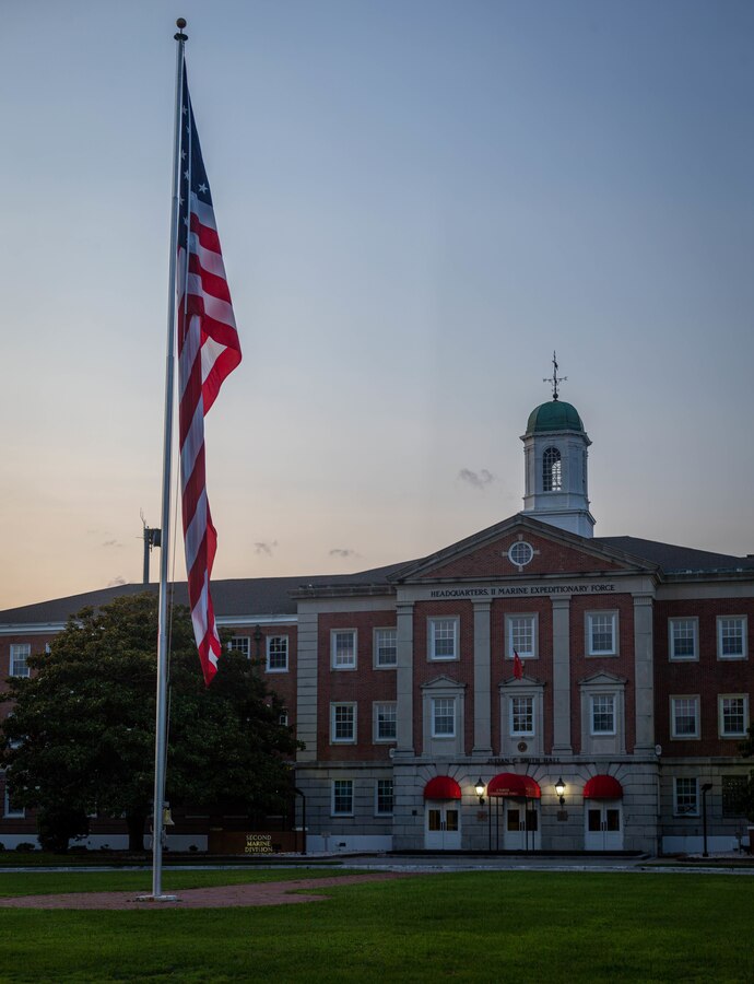 A garrison flag flies in the sky before being lowered during an evening colors ceremony on Camp Lejeune, N.C., July 4, 2021.