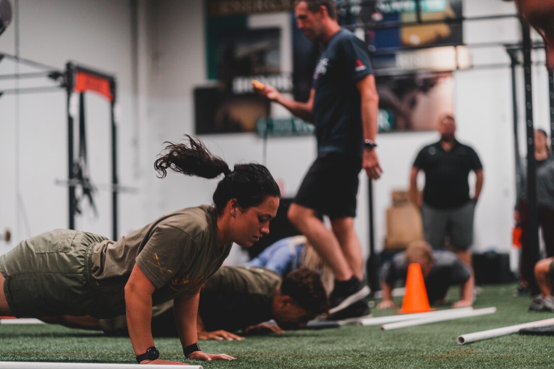 U.S. Marine Corps Staff Sgt. Ashlee Grissom, motor transport operations chief, 7th Marine Regiment, 1st Marine Division performs the push-up during an Aerobic Capacity seminar course at Marine Corps Air Ground Combat Center, Twentynine Palms, California, June 22-23, 2021. The 2-day course will teach the Marines a thorough understanding of how to improve their recovery as well as develop their cardiovascular "engine" and muscular stamina. (U.S. Marine Corps photo by Lance Cpl. Colton Brownlee)