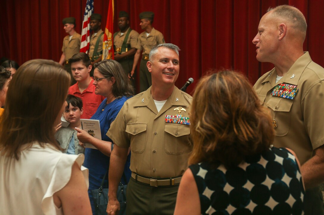 U.S. Marine Corps Col. Richard J. Schmidt, incoming commanding officer for Headquarters Battalion, Training and Education Command speaks with guests after the Headquarters Battalion, Training and Education Command, change of command at Breckinridge Hall on Marine Corps Base Quantico, Virginia, June 25, 2021. A change of command signifies a formal transfer of authority and responsibility for a unit from one commander to another. (U.S. Marine Corps Photo by Lance Cpl. Mitchell Johnson)
