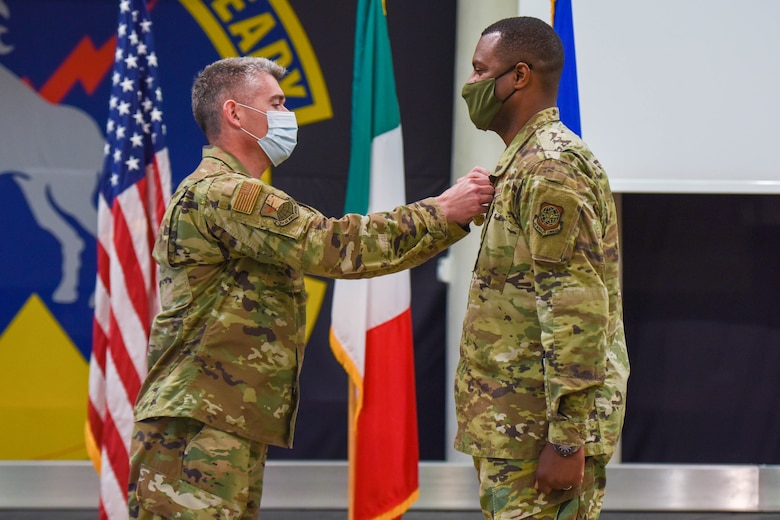 U.S. Air Force Col. Christopher Busque, 31st Mission Support Group commander, left, pins the Meritorious Service Medal (MSM) on U.S. Air Force Lt. Col. Anthonelli White, 724th Air Mobility Squadron outgoing commander, during a change of command ceremony at Aviano Air Base, Italy, July 6, 2021. The MSM is a military award presented to members of the United States Armed Forces who distinguished themselves by outstanding meritorious achievement. (U.S. Air Force photo by Airman 1st Class Brooke Moeder)