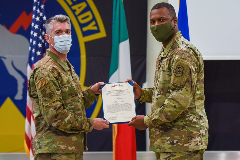U.S. Air Force Col. Christopher Busque, 31st Mission Support Group commander, left, and U.S. Air Force Lt. Col. Anthonelli White, 724th Air Mobility Squadron outgoing commander, pose for a photo during a change of command ceremony at Aviano Air Base, Italy, July 6, 2021. The 724th AMS is an Air Mobility Command tenant and supports the 31st Fighter Wing through deployments by completing airworthiness inspections, which measures an aircraft’s suitability for a safe flight prior to takeoff. (U.S. Air Force photo by Airman 1st Class Brooke Moeder)