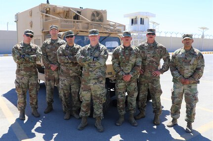 The 130th Field Artillery Brigade ADAM Cell assigned to Task Force Spartan, left to right, Capt. David Sanders, Chief Warrant Officer 2 Richard Machina, Chief Warrant Officer 2 Anthony Calanni, Spc. Bryce Manker, Spc. Christopher Dame, Staff Sgt. Chase Weber, and Staff Sgt. Johnathan Bustamante.