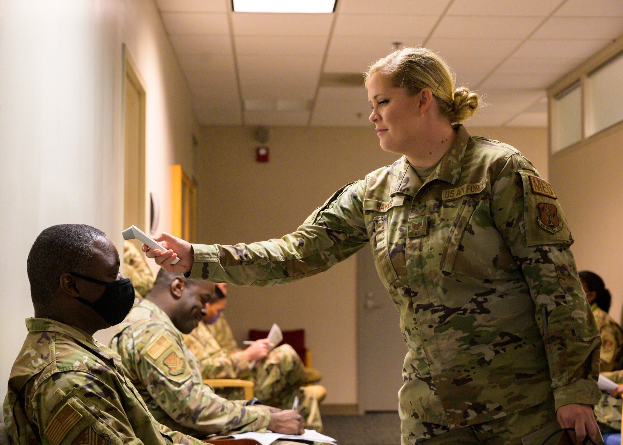 Georgia Air National Guard medic checks temperature Airman