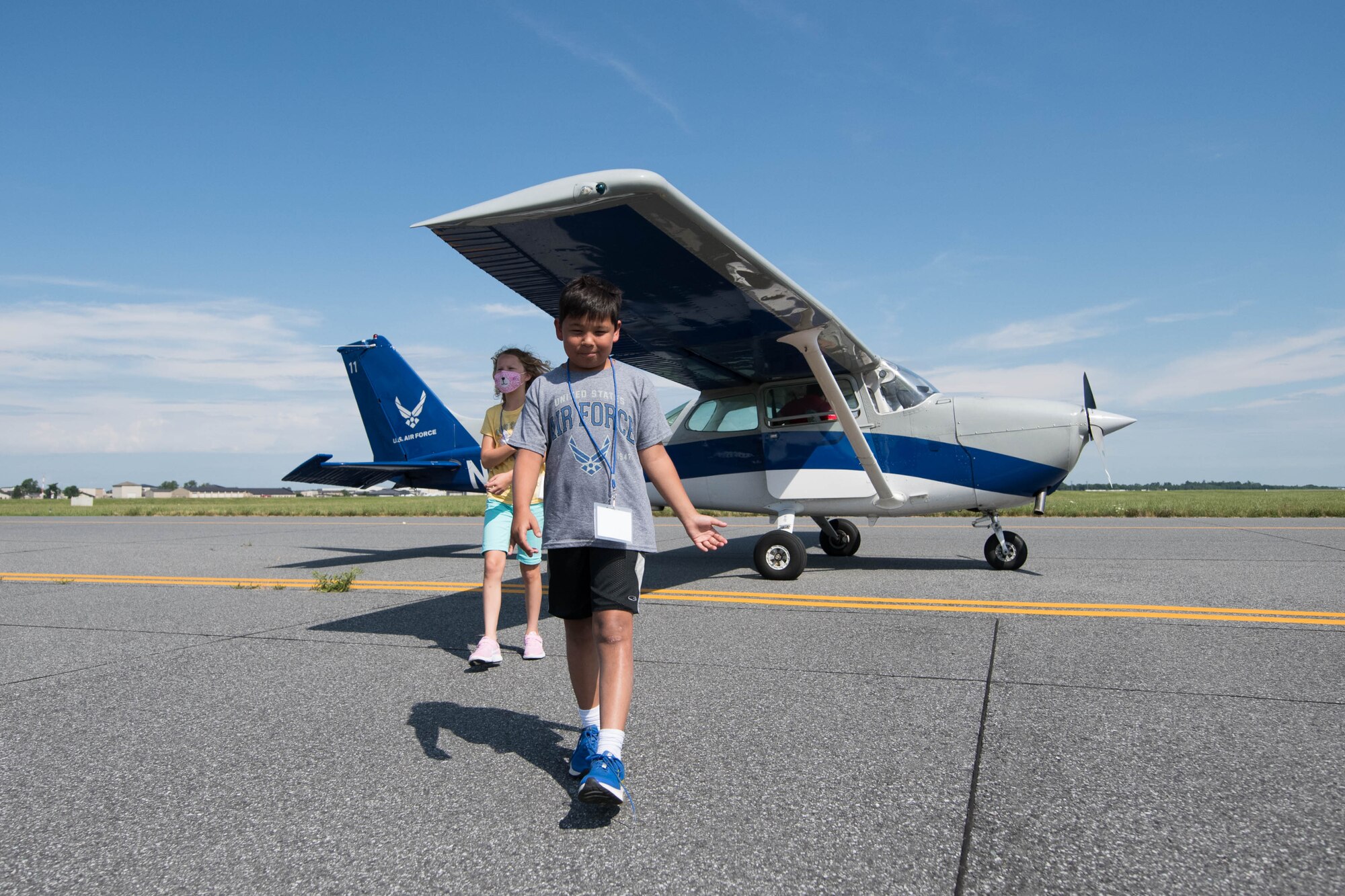 Ty Frazier and Noelle Robinson leave the runway after their flight in a Cessna 172 during a 2021 Aviation Summer Camp at the Air Mobility Command Museum in Dover, Delaware, July 1, 2021. During the camp, kids toured the AMC Museum and parts of Dover Air Force Base to learn about aviation. (U.S. Air Force photo by Mauricio Campino)