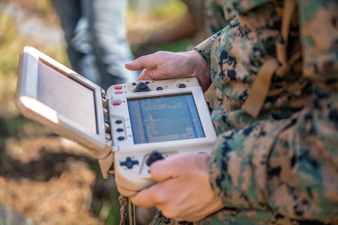 U.S. Marine Corps Sgt. Justice Rees, a Troy, Ohio, native and armory chief with 1st Battalion, 2d Marine Regiment, 2d Marine Division, rehearses maneuvering an Expeditionary Modular Autonomous Vehicle during a training event on Camp Lejeune, N.C., June 24, 2021. The purpose of this training is to provide electronic warfare services to a supported unit commander. The EMAV is a highly mobile and fully autonomous ground vehicle that has a payload capacity of 7,200 pounds.