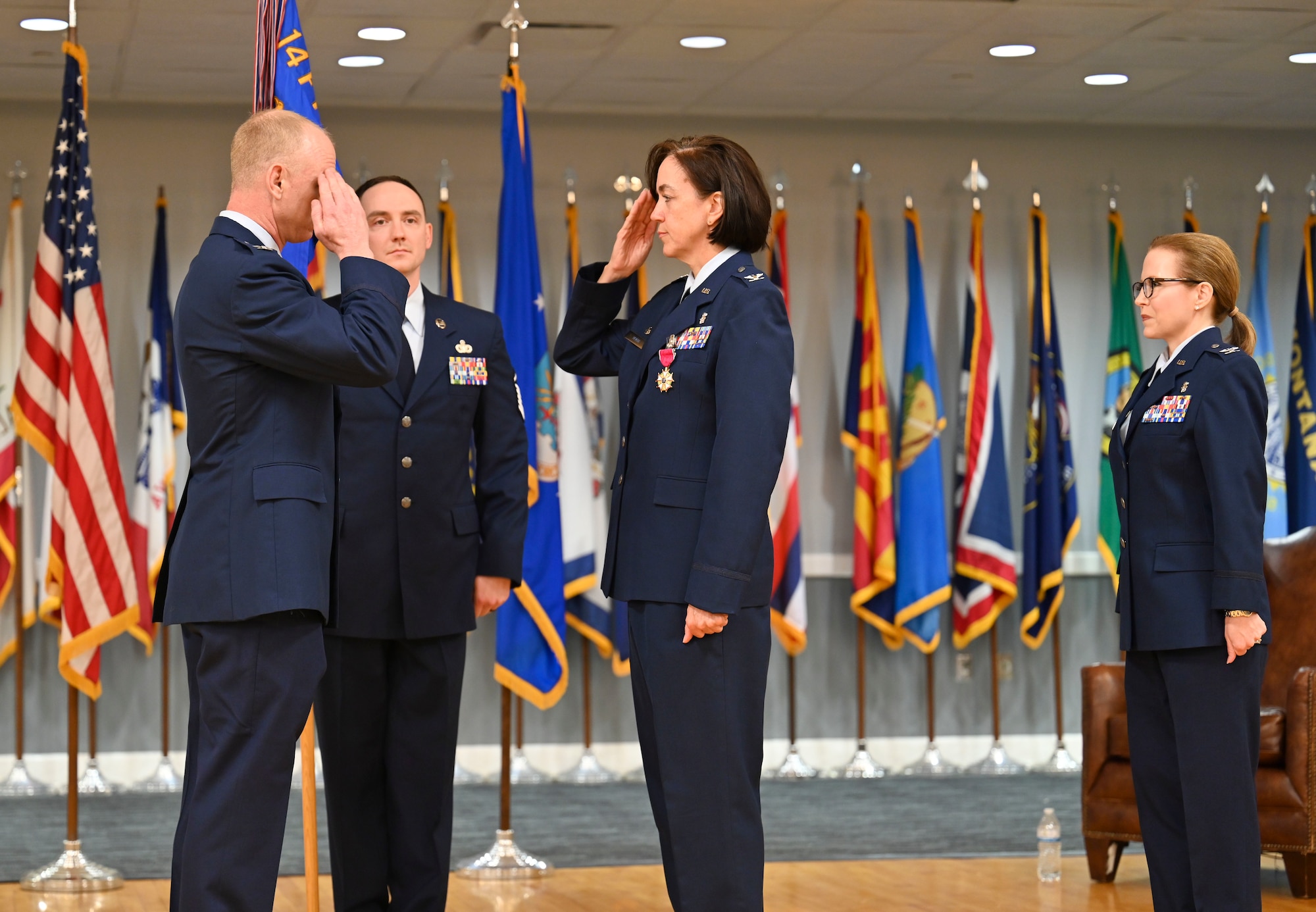 U.S. Air Force Col. Seth Graham, 14th Flying Training Wing commander, returns a salute to Col. Betty Venth, out-going 14th Medical Group commander, after presenting her with the Legion of Merit, during a Change of Command ceremony, July 6, 2021, on Columbus Air Force Base, Miss. The Legion of Merit is awarded to service members in key positions or responsibility for exceptionally meritorious conduct in the performance of outstanding serviced and achievements. (U.S. Air Force photo by Airman 1st Class Jessica Haynie)