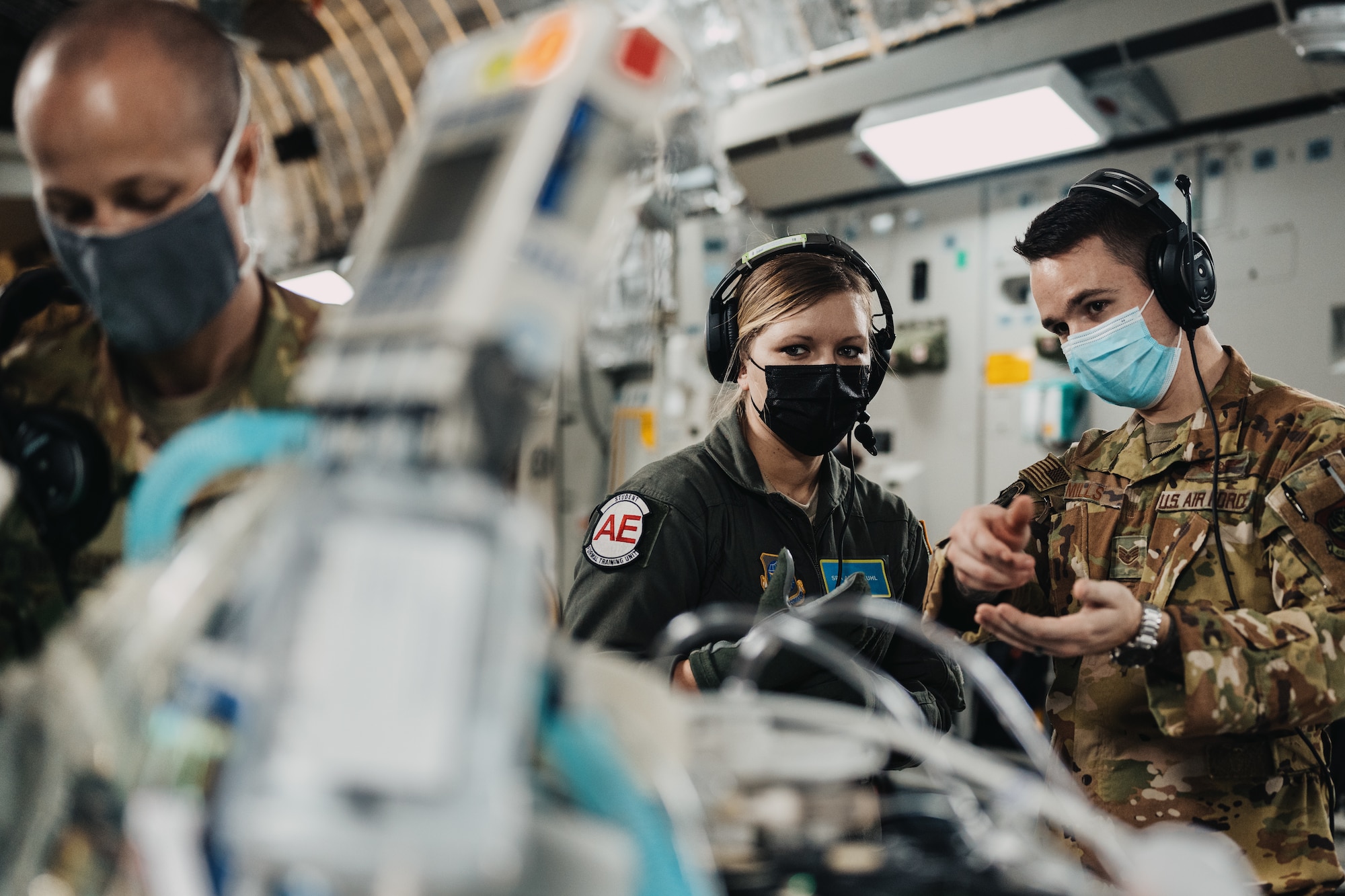 Staff Sgt. Ronald Mills, 375th Aeromedical Evacuation Training Squadron instructor, provides performance feedback to Senior Airman Ariel Kuhl, 932nd Aeromedical Evacuation Squadron technician-in-training during an Aeromedical Evacuation Initial Qualification course training mission on Wright-Patterson Air Force Base, Ohio, Dec. 3, 2020. Upon graduation students will continue to one of the 31 AESs across the world to support global patient movement. (U.S. Air Force photo by Tech. Sgt. Jordan Castelan)