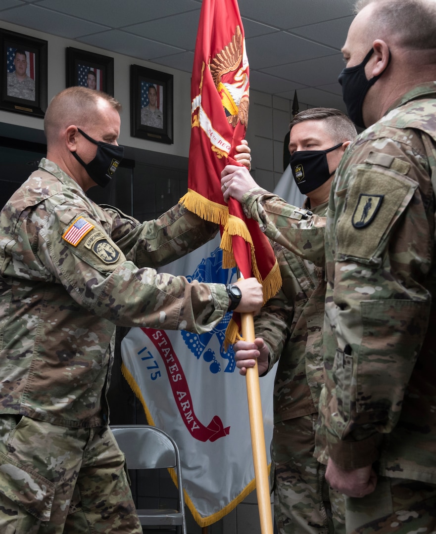 Col. William Wagner (center) accepts the guidon for the 124th Regiment (Regional Training Institute) from Brig. Gen. James Pabis (left) during the 124th RTI's change-of-command ceremony March 6, 2021, at Camp Johnson, Vermont. The 124th RTI is home to the Army Mountain Warfare School, Information Operations Battalion, Officer Candidate Scchool, and the Basic Leaders Course. Also pictured is Command Sgt. Maj. John Digby III (right), the 124th RTI command sergeant major. (U.S. Army National Guard photo by Don Branum)