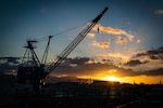 Pearl Harbor, Hawaii - Pearl Harbor Naval Shipyard & IMF, (February 11, 2021) Sunrise over the Ko`olau Mountains with portal crane P-76 in the foreground.