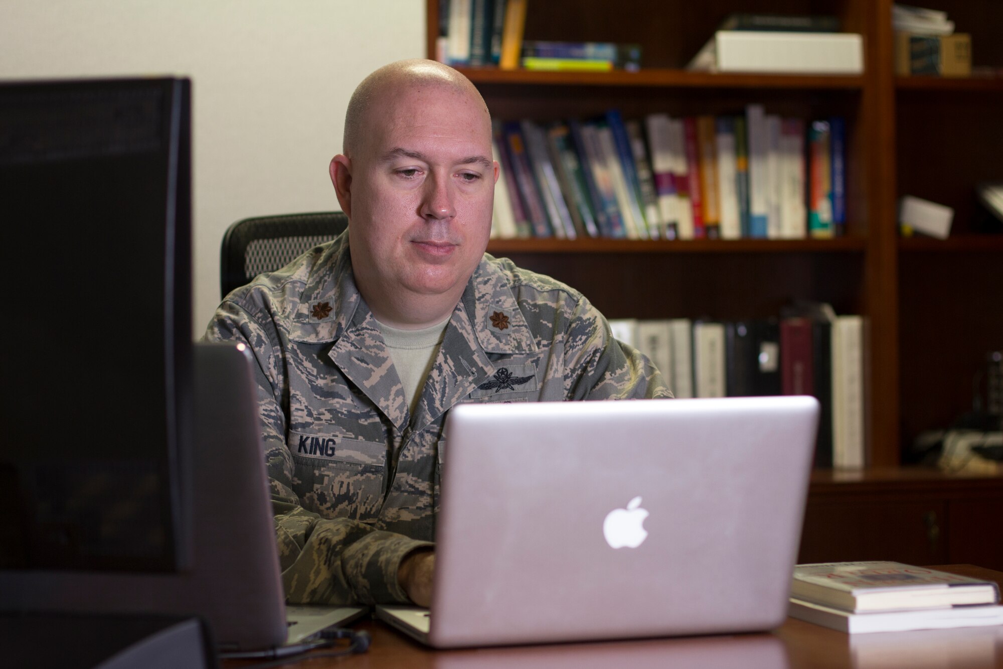 Major David King studies how to create and leverage emergent phenomena in complex systems with applications towards building and controlling adaptable robotic swarms at The Air Force Institute of Technology (AFIT). (Photos by Bruce Lambert, Ctr., Cyber Security Videographer.)