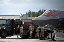 U.S. Airmen assigned to  the 354th Fighter Wing conduct a hot pit refueling on an F-35A Lightning II aircraft assigned to the 355th Fighter Squadron on Eielson Air Force Base, Alaska, July 7, 2021.