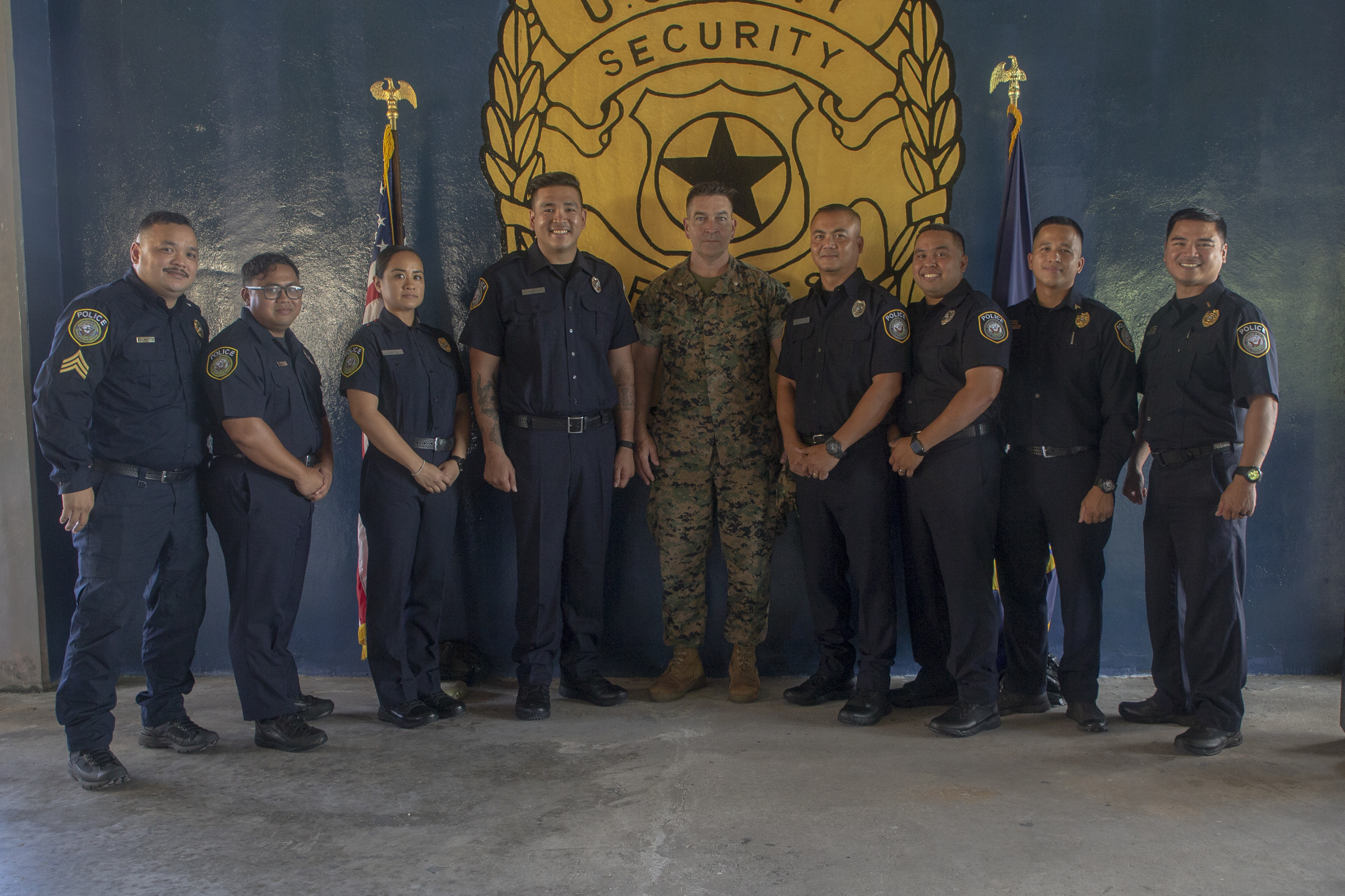 Navy Security Guard Training Course S-540-1012, Class 03-2021 graduates and their instructors pose for a group photo with Lt. Col. Tate Buntz, the MCB Camp Blaz Operations Officer, after a graduation ceremony on U.S. Naval Base Guam, July 6, 2021.