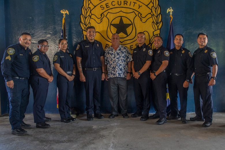 Navy Security Guard Training Course S-540-1012, Class 03-2021 graduates and their instructors pose for a group photo with Daniel Brindley, the MCB Camp Blaz Deputy Provost Marshal, after a graduation ceremony on U.S. Naval Base Guam, July 6, 2021.