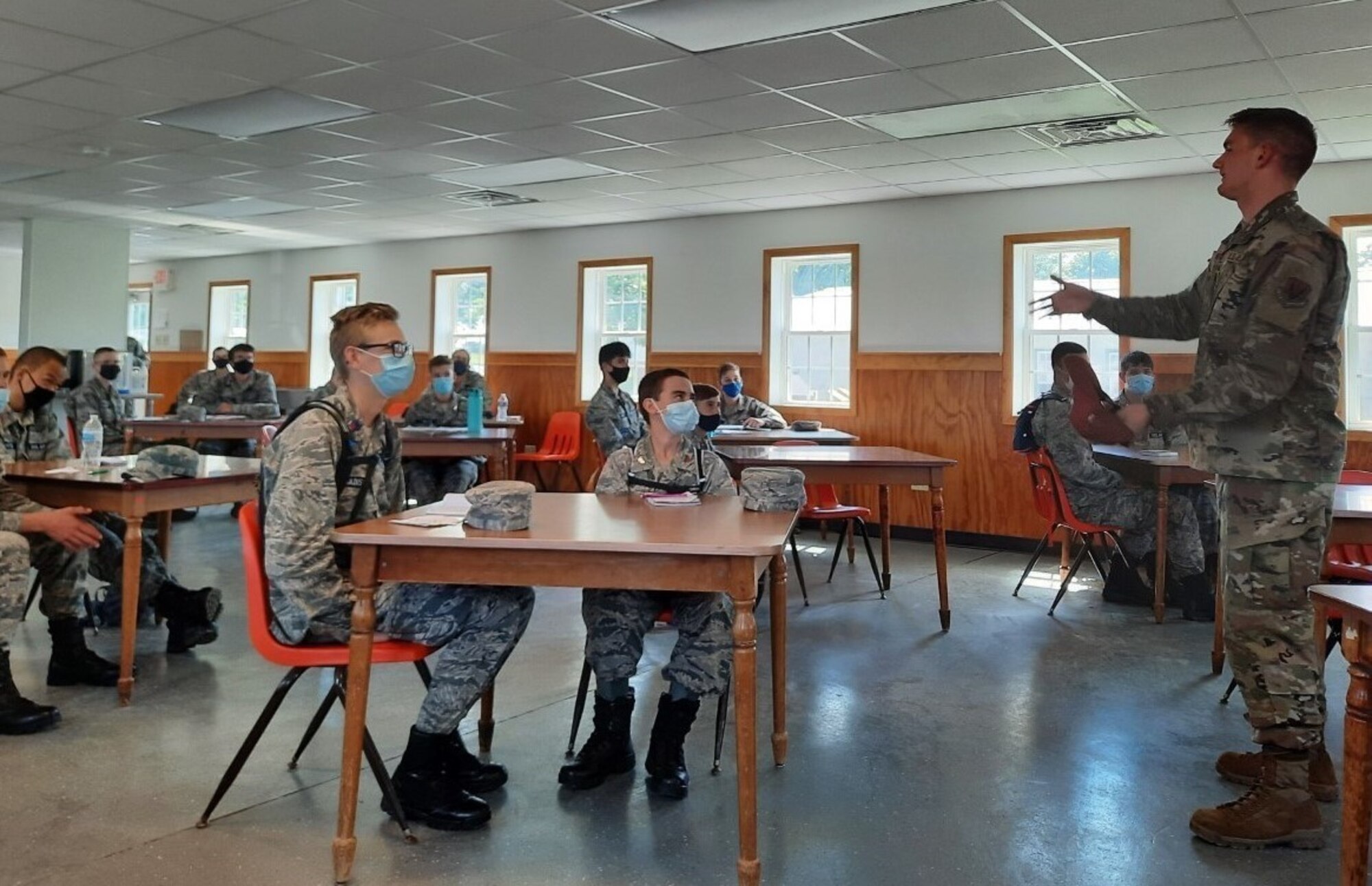 Airman 1st Class Matthias Krauter, right, a materiel management apprentice with the 193rd Special Operations Wing, addresses a group of Civil Air Patrol cadets participating in their annual encampment at Fort Indiantown Gap, Pennsylvania, on June 23, 2021. Krauter spent years as a Civil Air Patrol cadet and credits the organization with introducing him to the military and preparing him for challenges that are part of the military lifestyle. (Photo by Maj. Nicole Reigelman)