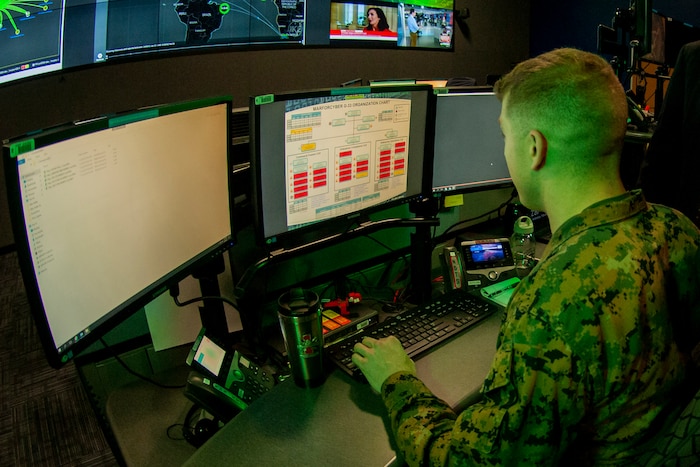A Marine operates a computer.