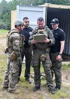 Staff Sgt. Adam Abderrazzaq, 387th explosive ordnance disposal technician, looks at x-rays of a potential explosive taken by the Massachusetts state police department bomb squad during a training scenario at Raven's Challenge Interoperability Exercise June 8, 2021, at Fort Devens Army Base, Devens, Massachusetts. The Soldiers spent a week at the exercise working with civilian public safety bomb squads training in various scenarios, focusing on interoperability between the agencies in operational environments while promoting teamwork and innovation.  (U.S. Air National Guard photo by Senior Airman Sara Kolinski)